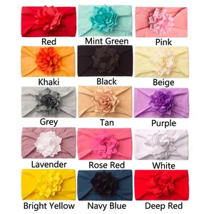 Set of 15 colorful flower baby headbands in soft elastic fabric on a white background