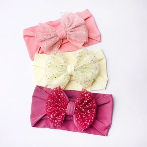 Three-piece set of soft nylon baby headbands with large sequined mesh bows in pink and yellow