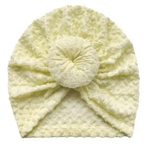Cute cream yellow waffle knit baby turban hat with donut knot decoration and soft texture