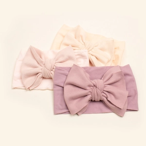 Set of three soft nylon baby headbands with large bows in mauve, pink and light orange