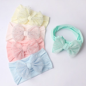 Five-pack of soft nylon baby headbands with sparkly mesh bows in assorted macaron colors