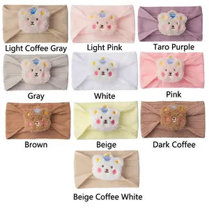 Ten-pack set of baby ribbed knit headbands with 3D plush bear charms in various soft colors