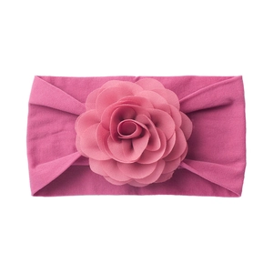 Close-up of soft rose purple elastic baby headband with a large layered fabric flower