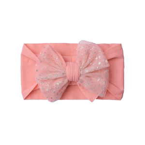 Detail of pink baby headband with large double-layered bow and silver sequin mesh