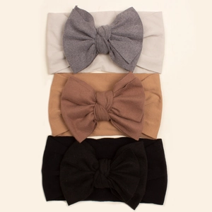 Three-piece set of large baby bow headbands in soft neutral elastic knitted fabric
