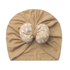 Comfortable baby beanie in khaki featuring a large polka dot bow for newborns and infants