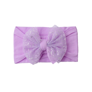 Detailed macro view of light purple nylon baby headband with sparkling mesh bow decoration