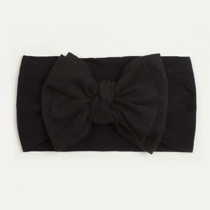 Detailed close-up of soft black nylon baby headband with a large elastic bow knot design