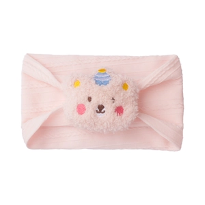 Detailed texture of pink knitted baby headband with a cute 3D plush bear head