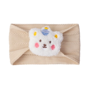 Close-up of beige cable knit baby headband with a cute plush bear wearing a tiny blue hat