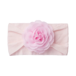 Detail of baby headband featuring soft light pink layered fabric flower on elastic knit fabric
