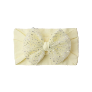Detail showing the layered yellow bow with silver glitter mesh on a nylon baby headband