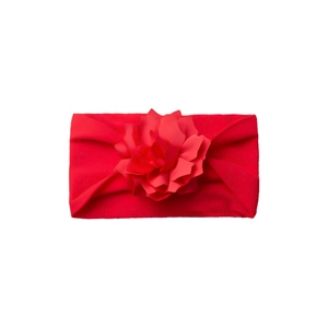 Detail of red elastic baby headband featuring a handmade multi-layered fabric flower