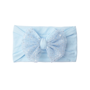 Close-up of baby headband showing soft light blue knit fabric and sequined mesh bow detail