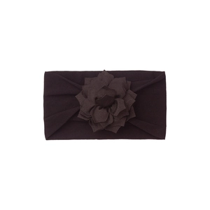Detail of baby headband with a large layered fabric flower in deep brown color
