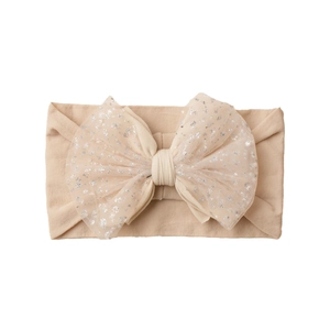 Detail of baby soft nylon headband with double-layered mesh glitter bow in beige