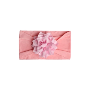 Detailed macro view of soft pink 3D handmade flower on high-elastic baby headband