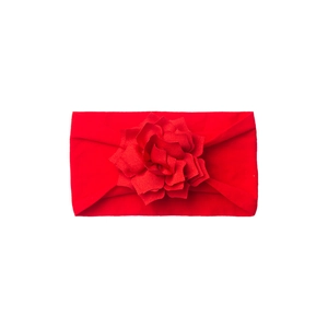 Detail of red baby headband featuring a large soft layered fabric flower on top