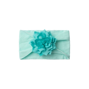 Close-up of mint green soft elastic baby headband with detailed layered fabric flower