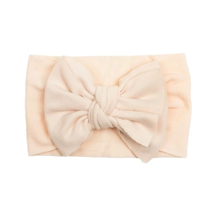 Soft nylon baby headband with a large bow in apricot color for newborn infants