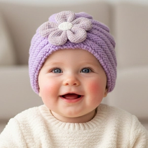 Close-up of purple knitted baby hat featuring a large 3D flower detail and soft texture