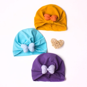 Three-pack soft elastic cotton baby turbans with large bows in yellow, blue, and purple