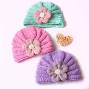 Three-pack of ribbed baby knit beanies with large floral accents in pastel colors