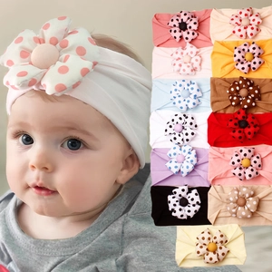 Detail view of elastic baby headbands featuring colorful polka dot 3D floral ornaments