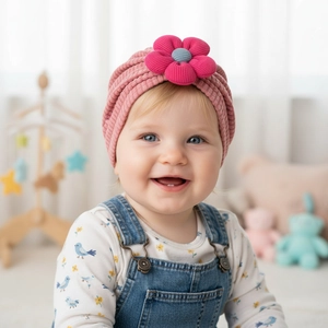 Close-up of pink baby turban hat featuring a large 3D flower with ribbed texture