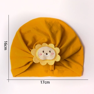 Close-up of yellow baby turban hat with lion sunflower patch showing size 16cm by 17cm