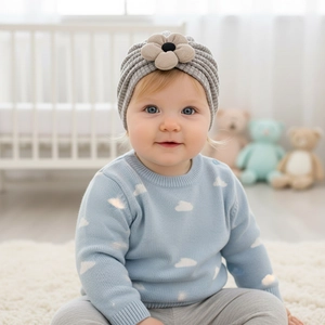 Close-up of baby knit headband in light grey with 3D beige flower detail and soft texture