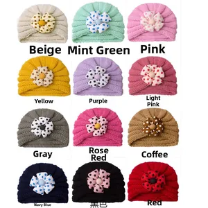 Grid view showing a variety of colors for knit baby turban hats with polka dot flowers