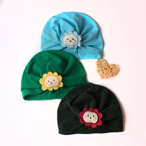Three cotton infant turban hats with cartoon lion sunflower patches in blue and green