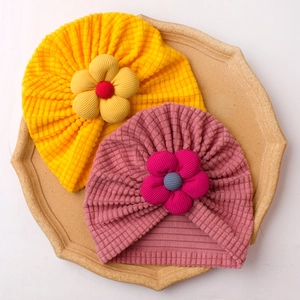 Cute solid color baby turban hats with large fabric flowers for warmth and wind protection
