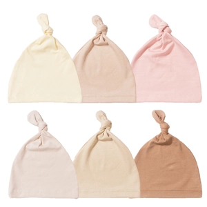 Set of six soft cotton knotted baby hats in gentle pastel tones for newborns and infants