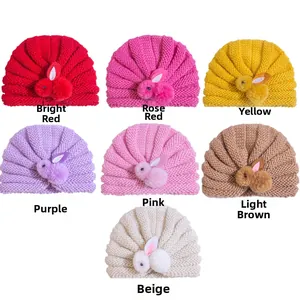 Knitted baby hats in seven colors featuring 3D plush bunny dolls on white background