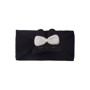 Close-up of baby nylon headband with white bow and cute bunny embroidery detail
