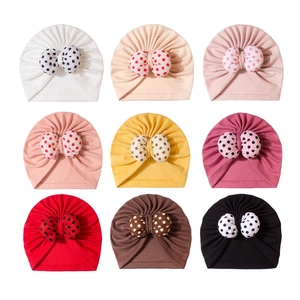 Set of 9 soft baby turban hats with polka dot bows in various colors for newborns