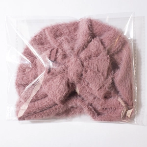 Detailed view of pink faux rabbit fur baby turban hat with twisted knot in soft plush