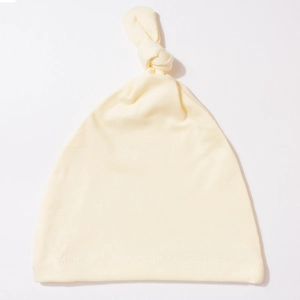 Detailed view of soft beige knitted baby knot hat with smooth double-needle stitching