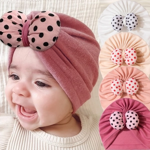 Newborn baby turban hat with a large polka dot bow in soft pink and various colors