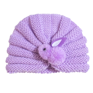Detail of soft purple knitted baby hat with a cute 3D bunny rabbit ornament