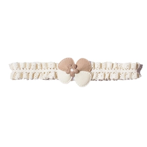 Baby lace headband with decorative floral bow and ruffled edges on a white background