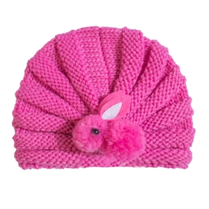 Detailed macro view of the knitted texture and plush bunny decor on this infant beanie