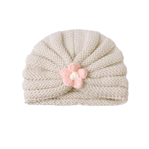 Chic autumn winter baby knitted hat in cream white featuring a cute handmade pink flower