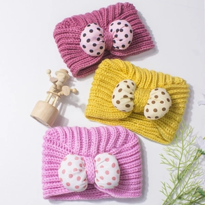 Soft knit baby beanies with cute polka dot bows in multiple colors for winter warmth