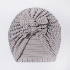 Macro detail of grey baby turban hat featuring waffle knit fabric and double bow decoration