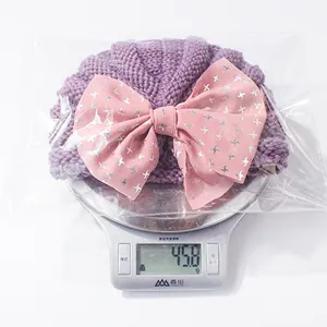 Detailed top view of purple baby turban hat weighing 45.8g on a digital scale