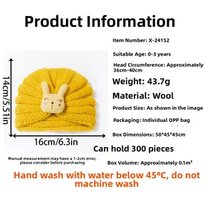 Detail of yellow knit baby hat featuring cute rabbit patch and ribbed ear protection