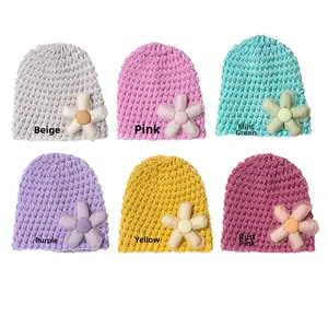 Detailed grid of baby knitted hats in six pastel colors featuring floral decorations